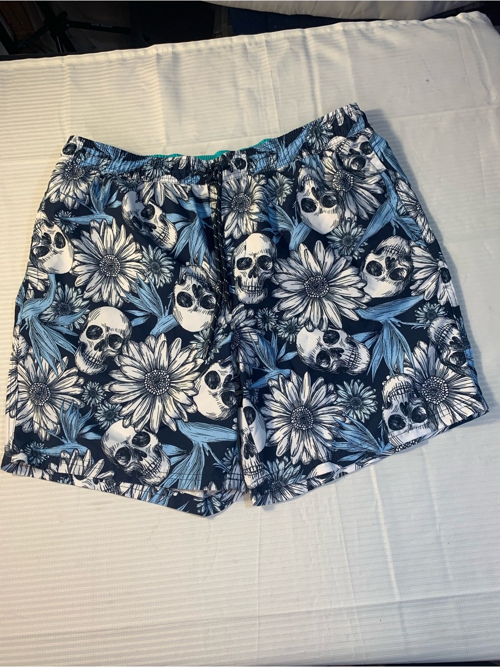 No Boundaries swim trunks feature a distinctive skull and floral pattern. SZ L